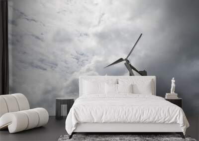 The small wind turbine under the cloudy sky in the countryside farm. Wall mural