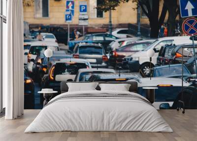 Heavy traffic on the street with many cars at rush hour. Concept of a traffic jam in the city Wall mural