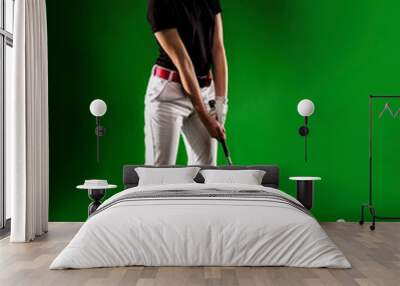 Girl looking for the perfect golf shot isolated on green background, full length Wall mural