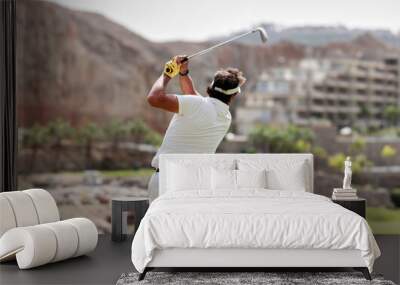 The golfer hits the golf ball with the Drive in his hand, on the tee. Wall mural