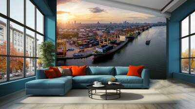 Aerial view of international port with Crane loading containers in import export business logistics with cityscape of Bangkok city Thailand at sunrise Wall mural