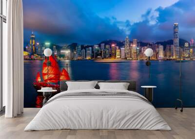 Panorama of Hong Kong City skyline with tourist sailboat at night. View from across Victoria Harbor HongKong. Wall mural