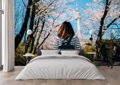 Young woman traveler backpacker traveling into N Seoul Tower at Namsan Mountain in Seoul City, South Korea Wall mural