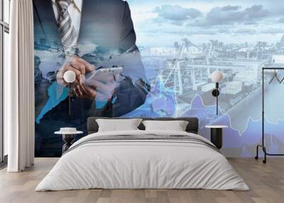 Businessman trading stocks online is pressing button on touch screen interface in front of Container Cargo ship and Cargo plane with Logistic import export and transport industry background Wall mural