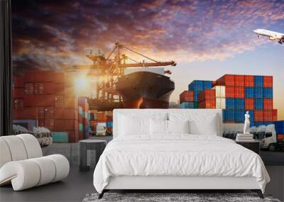 Container truck in ship port for business Logistics and transportation of Container Cargo ship and Cargo plane with working crane bridge in shipyard at sunrise, logistic import export and transport  Wall mural