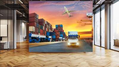 Container truck in ship port for business Logistics and transportation of Container Cargo ship and Cargo plane with working crane bridge in shipyard at sunrise, logistic import export and transport  Wall mural