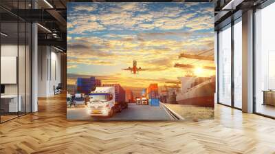 Container truck in ship port for business Logistics and transportation of Container Cargo ship and Cargo plane with working crane bridge in shipyard at sunrise, logistic import export  concept Wall mural