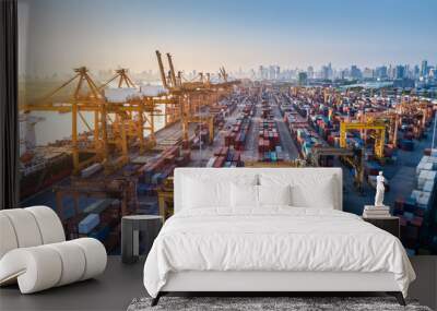 Logistics and transportation of Container Cargo ship and Cargo plane with working crane bridge in shipyard at sunrise, logistic import export and transport industry background Wall mural