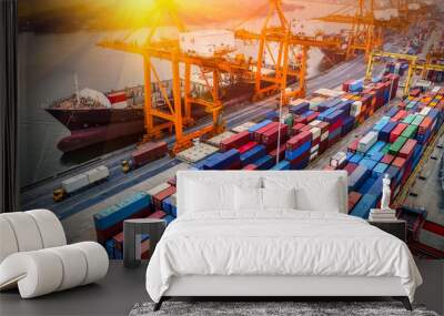 Logistics and transportation of Container Cargo ship and Cargo plane with working crane bridge in shipyard at sunrise, logistic import export and transport industry background Wall mural