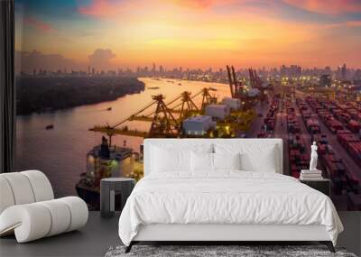 Logistics and transportation of Container Cargo ship and Cargo plane with working crane bridge in shipyard at sunrise, logistic import export and transport industry background Wall mural