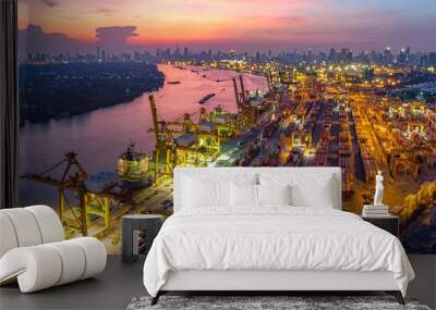 Logistics and transportation of Container Cargo ship and Cargo plane with working crane bridge in shipyard at sunrise, logistic import export and transport industry background Wall mural