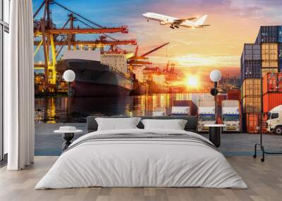 Logistics and transportation of Container Cargo ship and Cargo plane with working crane bridge in shipyard at sunrise, logistic import export and transport industry background Wall mural