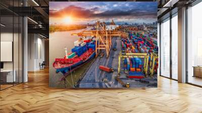 Logistics and transportation of Container Cargo ship and Cargo plane with working crane bridge in shipyard at sunrise, logistic import export and transport industry background Wall mural