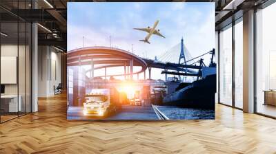 Logistics and transportation of Container Cargo ship and Cargo plane with working crane bridge in shipyard at sunrise, logistic import export and transport industry background Wall mural