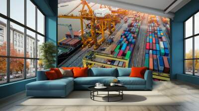 Logistics and transportation of Container Cargo ship and Cargo plane with working crane bridge in shipyard at sunrise, logistic import export and transport industry background Wall mural