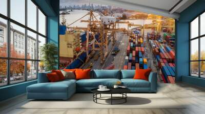 Logistics and transportation of Container Cargo ship and Cargo plane with working crane bridge in shipyard at sunrise, logistic import export and transport industry background Wall mural