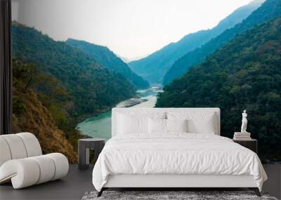 Spectacular view of the sacred Ganges river flowing through the green mountains of Rishikesh, Uttarakhand, India. Wall mural