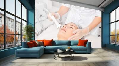 Cosmetologist makes ultrasound skin tightening for rejuvenation woman face using phonophoresis Wall mural