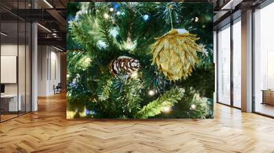 Festive New Year Christmas tree with pine cone decorations with garlands lights, close up view copy space, merry Christmas and happy New Year, essence of holiday cheer and joyous spirit Wall mural