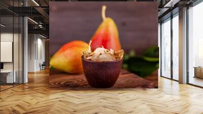 Close-up of sliced homemade dried pears in wooden cup with two fresh red pears background. Concept of healthy and vegetarian food. Wall mural