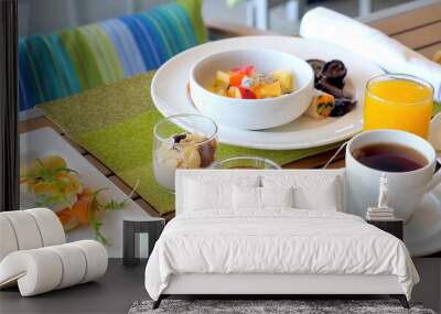 Hotel table with breakfast food. Served meal in modern tropical resort. Dinner for two in restaurant with fresh fruits, juices, eggs and cereals. Holiday, vacation, weekend concept Wall mural