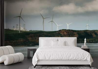 Wind towers at in Southern Australia with moody sky and aluminium smelter in the background. Wall mural