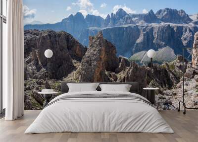 Panorama picture of a typical Alpine landscape in the Italian Alps: rough mountain rocks crossed by trails. High Dolomite peaks are visible in far distance. Puez-Odle natural park, South Tyrol, Italy Wall mural