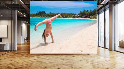 adorable happy little girl have fun at shallow water on beach Wall mural