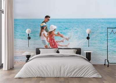 Adorable kids and their dad at beach during summer vacation Wall mural