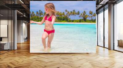 Adorable little girl at beach during summer vacation Wall mural