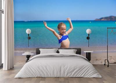 Adorable little girl have fun on tropical white sandy beach Wall mural