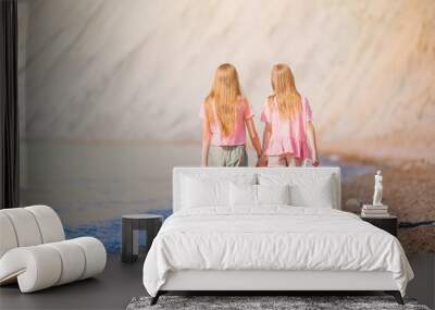 Adorable little girls having fun on the beach Wall mural