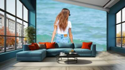 Adorable teen girl on the beach enjoy her summer vacation Wall mural