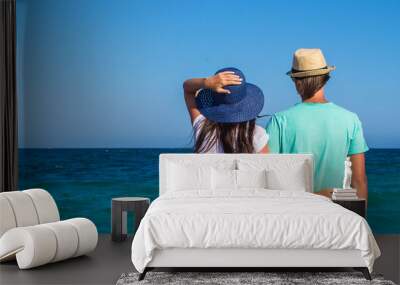 Back view of romantic couple at white beach during tropical Wall mural