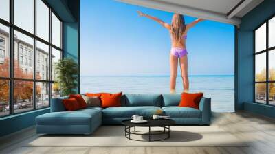 Cute little girl at beach during caribbean vacation Wall mural