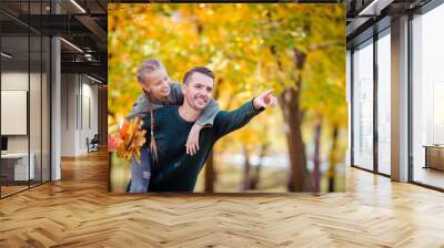 Family of dad and kid on beautiful autumn day in the park Wall mural