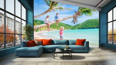 Happy beautiful family on a tropical beach vacation Wall mural