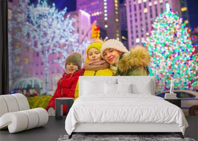 Happy family on the background of the Rockefeller Christmas tree in New York Wall mural