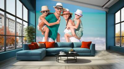 Happy family with kids on the beach together Wall mural