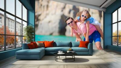 Happy father and his adorable little daughter at tropical beach having fun Wall mural