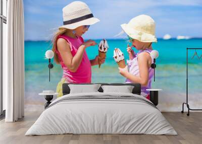 happy little girls eating ice-cream over summer beach background. people, children, friends and frie Wall mural