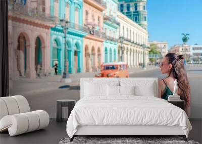 Happy woman in popular area in old Havana, Cuba. Young girl traveler background colorful houses Wall mural