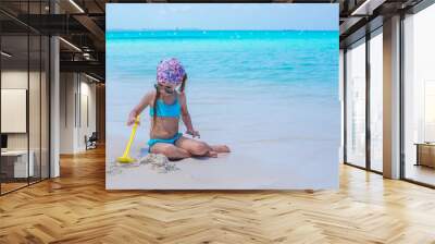 Little adorable girl on seashore during summer vacation Wall mural