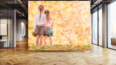 Little adorable girls outdoors at warm sunny autumn day Wall mural