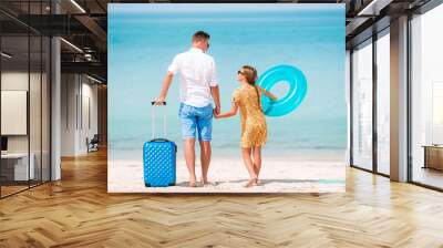 Little girl and happy dad having fun during beach vacation Wall mural