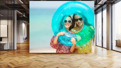 Little happy funny girls have a lot of fun at tropical beach playing together. Wall mural