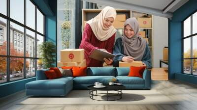 Friend muslim female two work business sme online shopping working on laptop computer with parcel box on desk at home, SME online business and delivery concept Wall mural