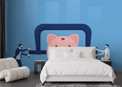 Business or company cut budget or reduce spending due to business crisis, businessman using clamp to squeeze saving pink piggy bank Wall mural