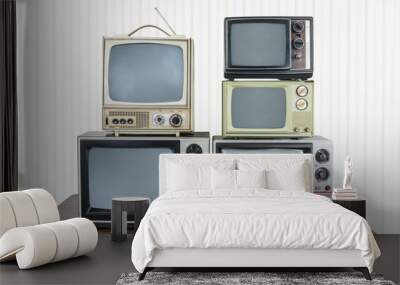 Five vintage televisions stacked on old wood table. Wall mural