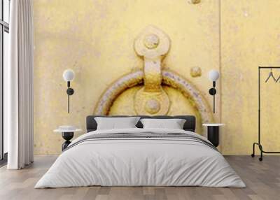 rusty metal yellow old door with a forged handle ring Wall mural